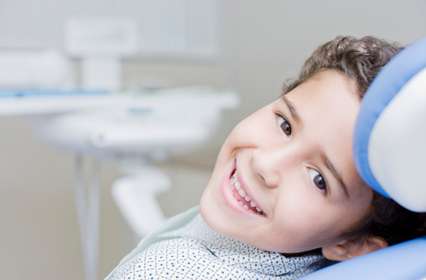 Young boy smiling with healthy teeth at Singing River Dentistry.