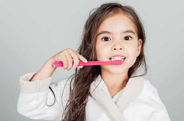 Singing River Dentistry patient brushing her teeth